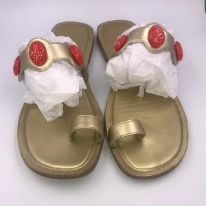 Gold flat sandals with coral accents